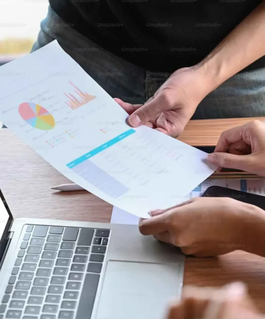 Business consultant reviewing strategy documents with a client in a modern office